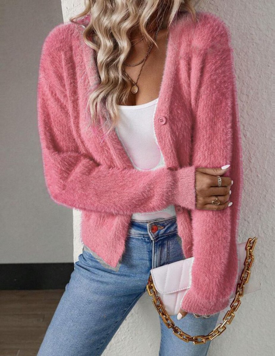 Coraline fuzzy V-neck cardigan in pink, layered over white top