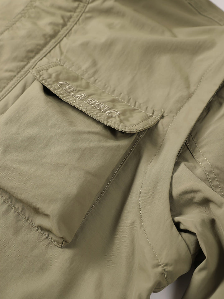 Close-up of Emerson cargo jacket chest pocket with embroidered logo patch