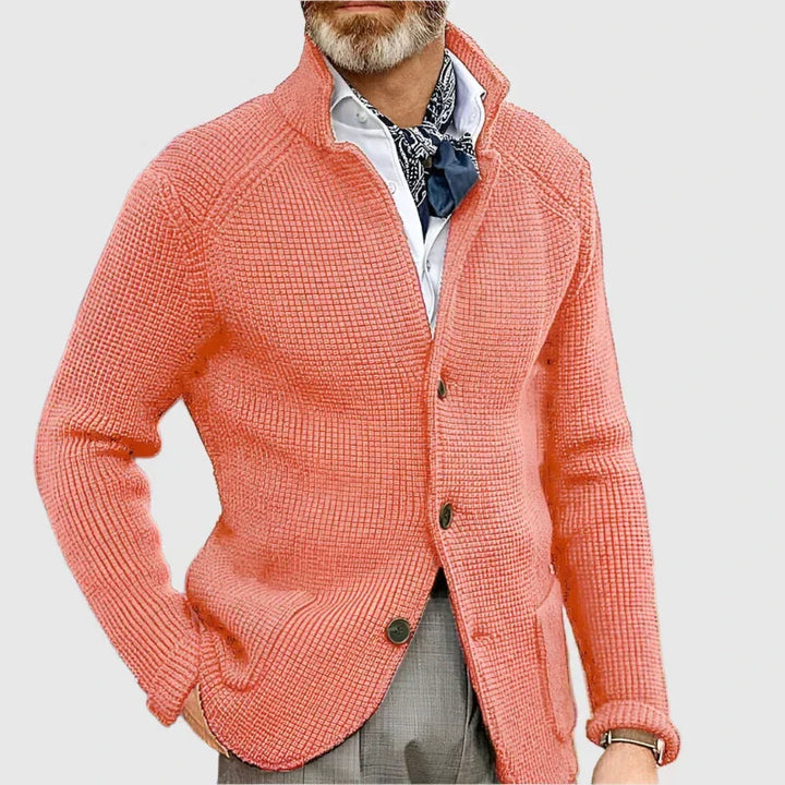 Man wearing coral stand collar button front knit cardigan, close-up