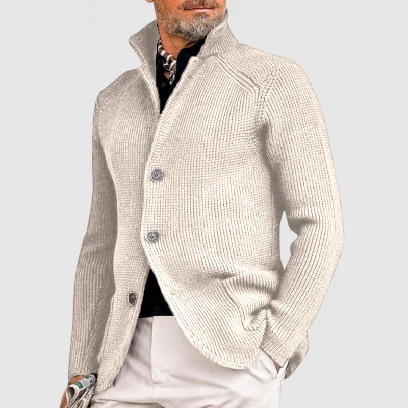 Man wearing beige stand collar button front knit cardigan, side view