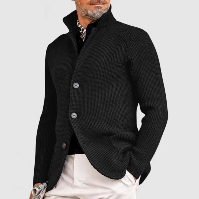 Man wearing black stand collar button front knit cardigan, side view