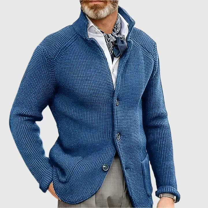Man wearing blue stand collar button front knit cardigan, close-up
