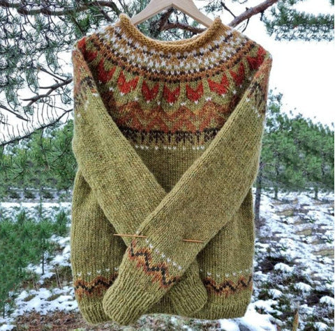 Freya green Fair Isle knit sweater with patterned yoke, hanging outdoors front view