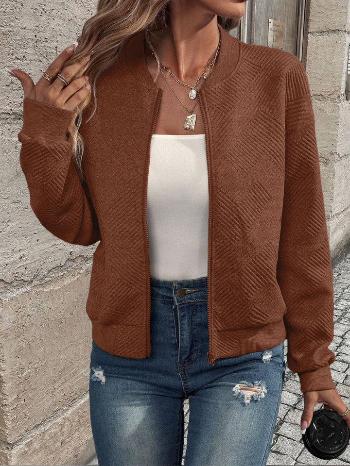 Genevieve textured zip-up bomber jacket in white, styled with jeans and handbag