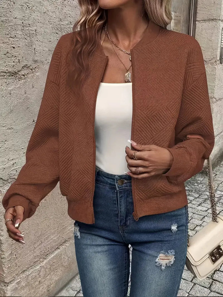 Genevieve textured zip-up bomber jacket in white, styled with jeans and handbag