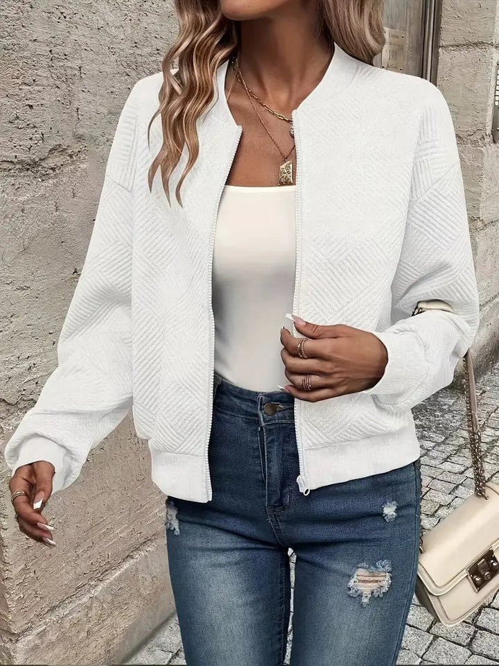 Genevieve textured zip-up bomber jacket in white, styled with jeans and handbag