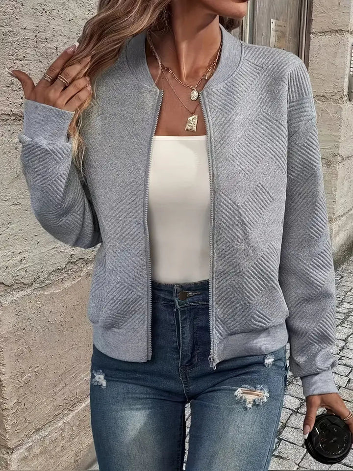 Genevieve textured zip-up bomber jacket in white, styled with jeans and handbag