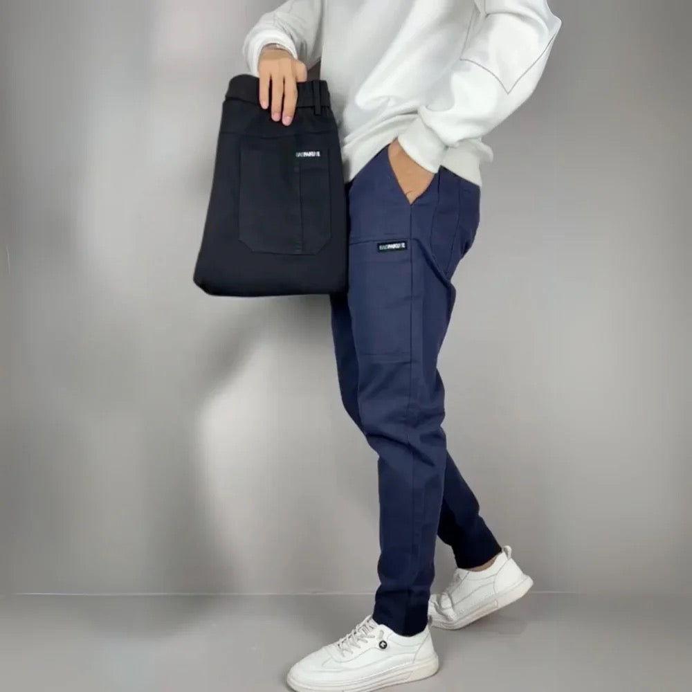 Julian cargo joggers shown in navy and black, side pose with bag