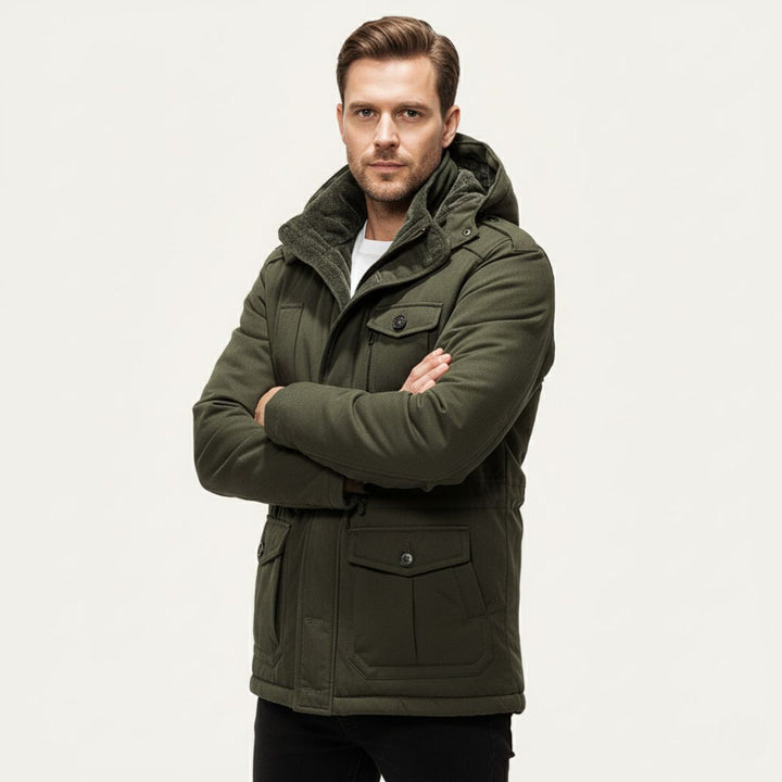 Man wearing Landon olive green parka with arms crossed