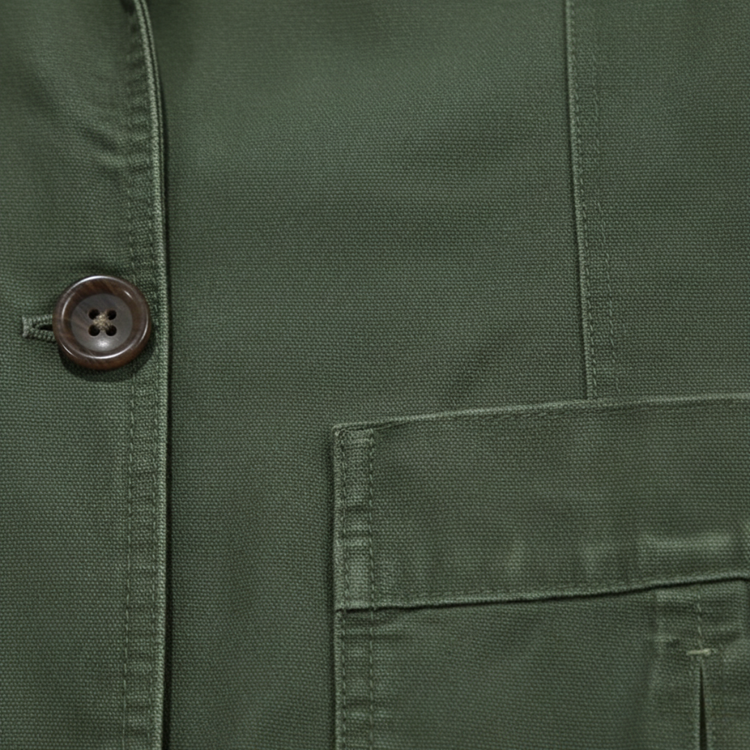 Close-up of Lawrence blazer button and patch pocket detail in army green