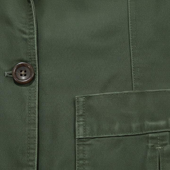 Close-up of Lawrence blazer button and patch pocket detail in army green