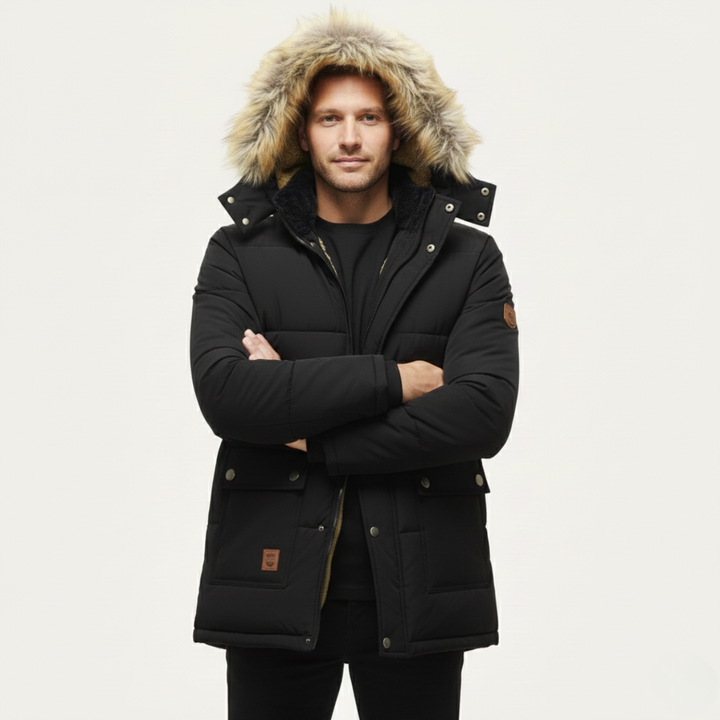 Marcus black hooded parka with faux fur trim, front view worn by model with arms crossed