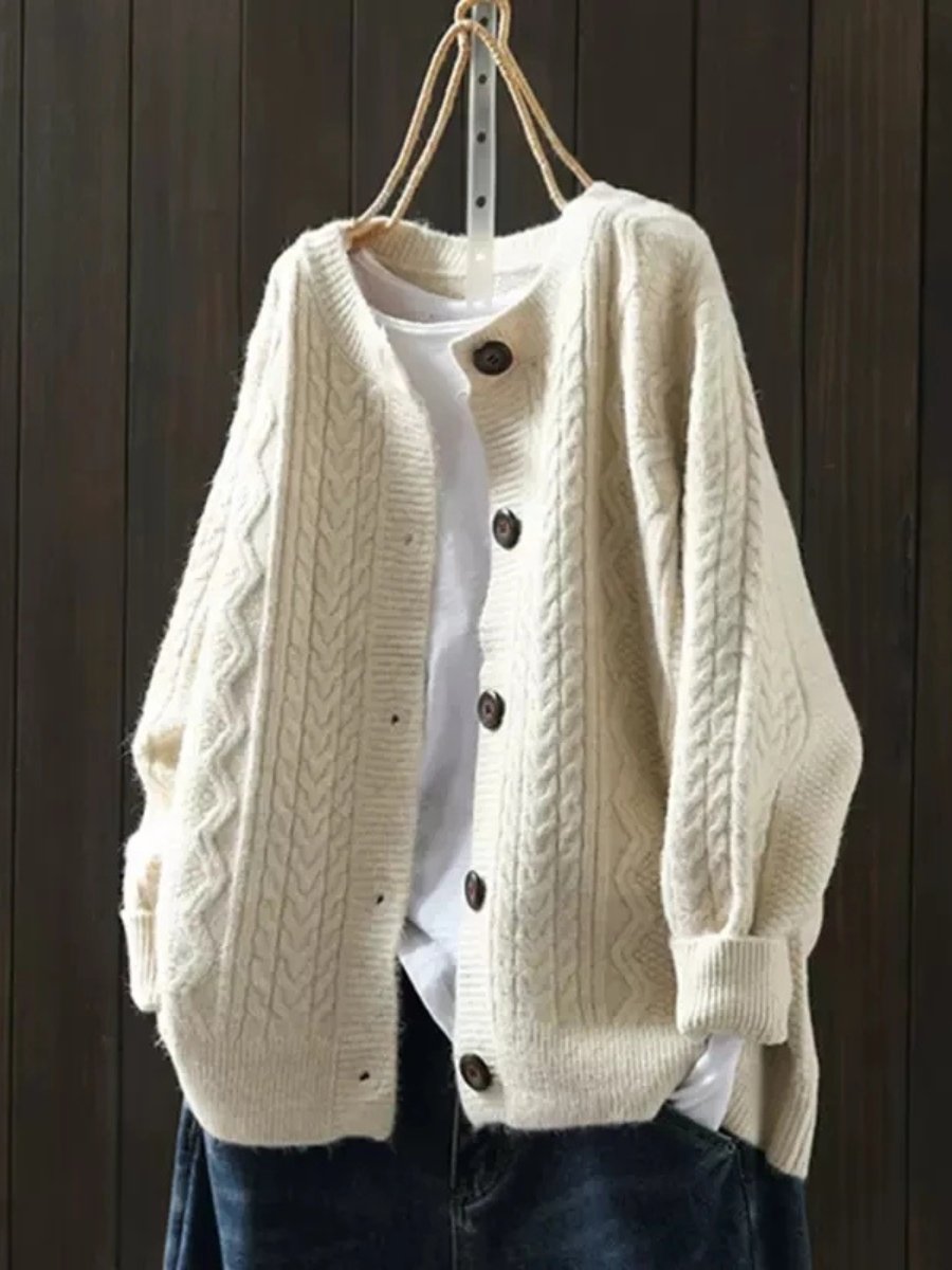 Marguerite oversized cable knit cardigan in beige, front view on hanger