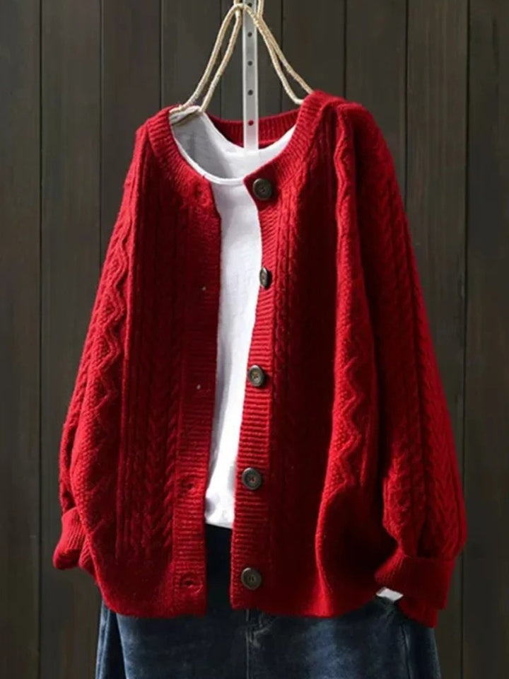Marguerite oversized cable knit cardigan in red, front view on hanger