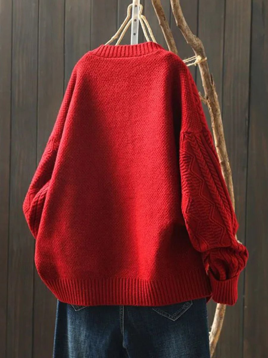 Marguerite oversized cable knit cardigan in red, back view on hanger