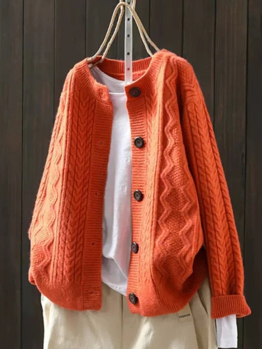 Marguerite oversized cable knit cardigan in navy blue, front view on hanger