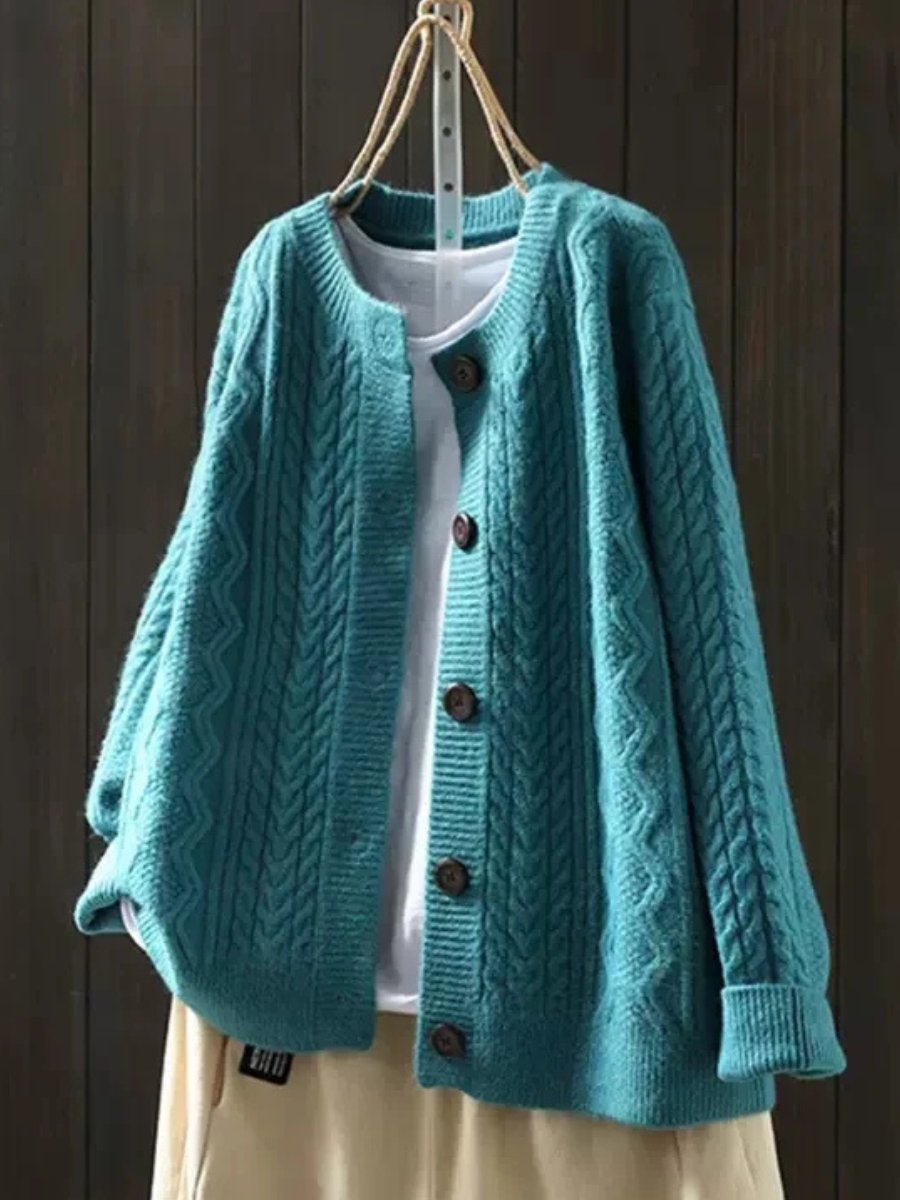 Marguerite oversized cable knit cardigan in navy blue, front view on hanger