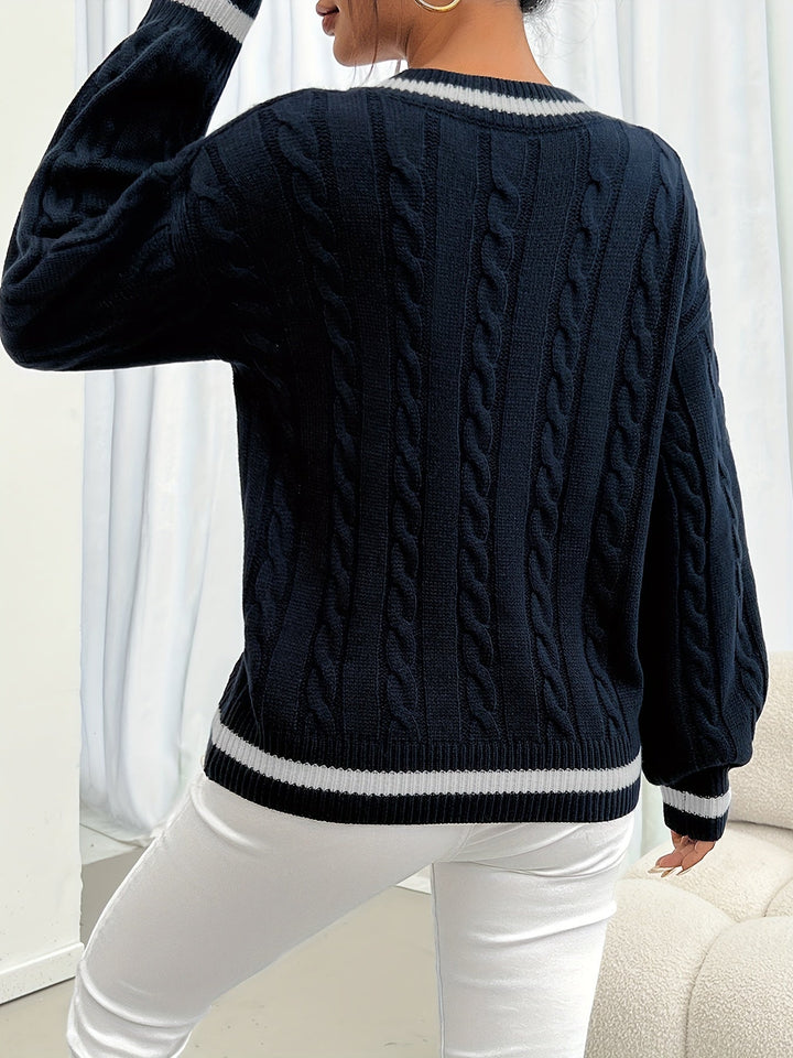 Marlowe cable-knit sweater, back view showing contrast hem
