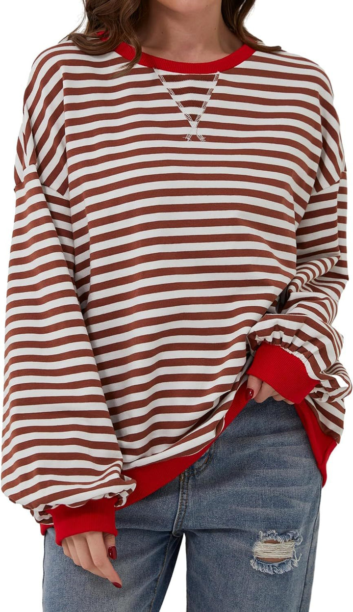 Priscilla pink and green striped oversized sweater, lifestyle shot with coffee cup