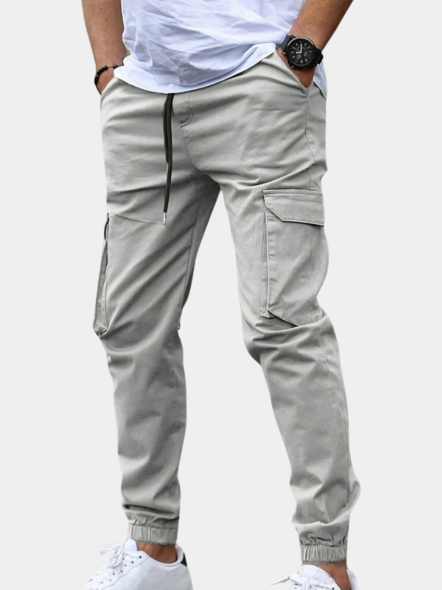 Ronan light gray cargo jogger pants, side view with hands in pockets