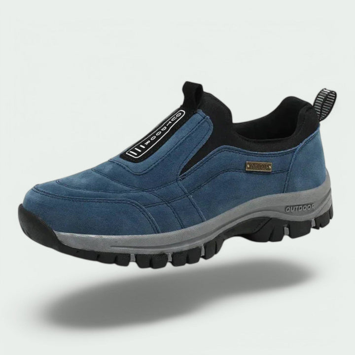 Thaddeus orthopedic slip-on walking sneaker in blue suede, floating side angle view