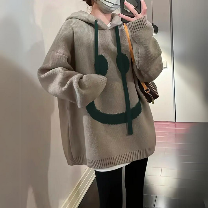 Thomasina oversized smiley hoodie in khaki, close-up front view with crossbody bag